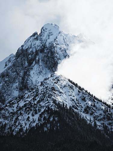 mountain range snowy mountain covered with clouds crest